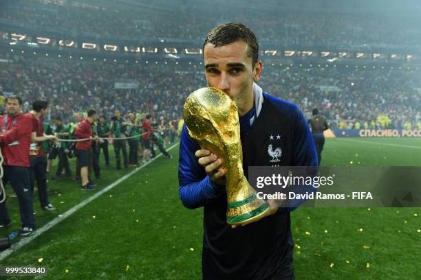 Antoine Griezmann of France kisses the World Cup trophy in celebration, following the 2018 FIFA World Cup Final between France and Croatia at...