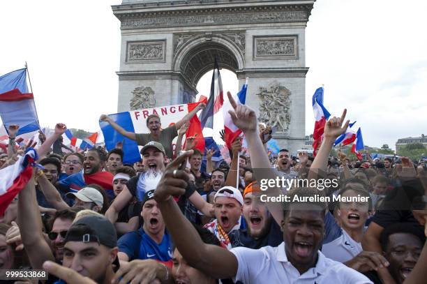 French fans gather on the Arc de Triomphe to celebrate the victory of France over Croatia 4-2 during the World Cup on July 15, 2018 in Paris, France.