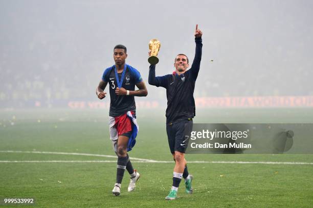 Presnel Kimpembe and Antoine Griezmann of France celebrate victory following the 2018 FIFA World Cup Final between France and Croatia at Luzhniki...