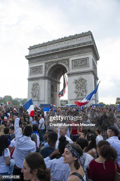 French fans gather on the Arc de Triomphe to celebrate the victory of France over Croatia 4-2 during the World Cup on July 15, 2018 in Paris, France.