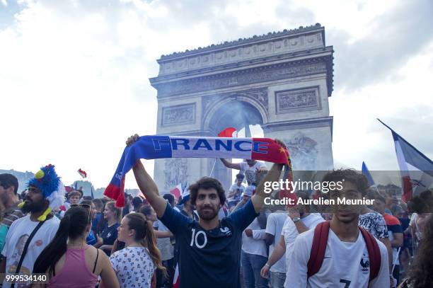 French fans gather on the Arc de Triomphe to celebrate the victory of France over Croatia 4-2 during the World Cup on July 15, 2018 in Paris, France.