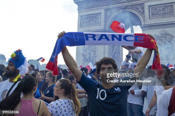 French fans gather on the Arc de Triomphe to celebrate the victory of France over Croatia 4-2 during the World Cup on July 15, 2018 in Paris, France.