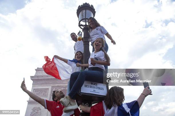 French fans gather on the Arc de Triomphe to celebrate the victory of France over Croatia 4-2 during the World Cup on July 15, 2018 in Paris, France.