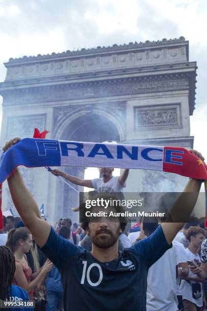 French fans gather on the Arc de Triomphe to celebrate the victory of France over Croatia 4-2 during the World Cup on July 15, 2018 in Paris, France.