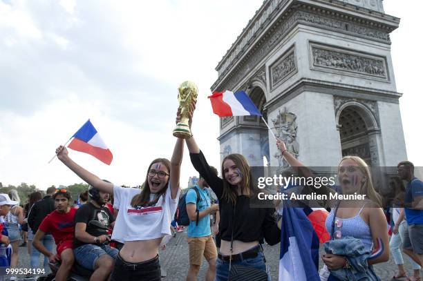 French fans gather on the Arc de Triomphe to celebrate the victory of France over Croatia 4-2 during the World Cup on July 15, 2018 in Paris, France.