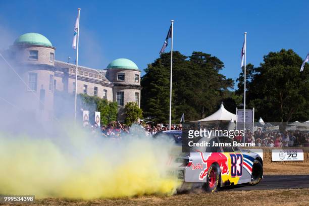 Patrick Friesacher of Austria performs donuts in the Red Bull Racing NASCAR during the Goodwood Festival of Speed at Goodwood on July 15, 2018 in...