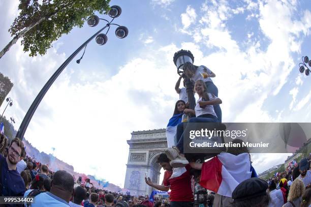 French fans gather on the Arc de Triomphe to celebrate the victory of France over Croatia 4-2 during the World Cup on July 15, 2018 in Paris, France.