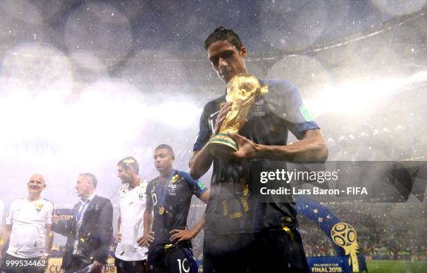 Raphael Varane of France holds the World Cup trophy following the 2018 FIFA World Cup Final between France and Croatia at Luzhniki Stadium on July...