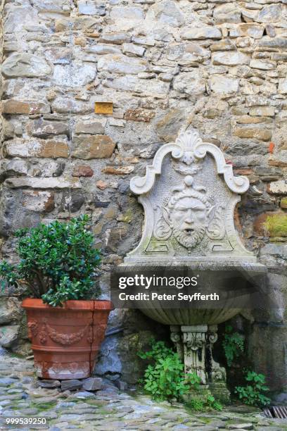 fountain and a terracotta flower pot, medieval village of dolceaqua, province of imperia, liguria, italian riviera, italy - peter wells stock pictures, royalty-free photos & images
