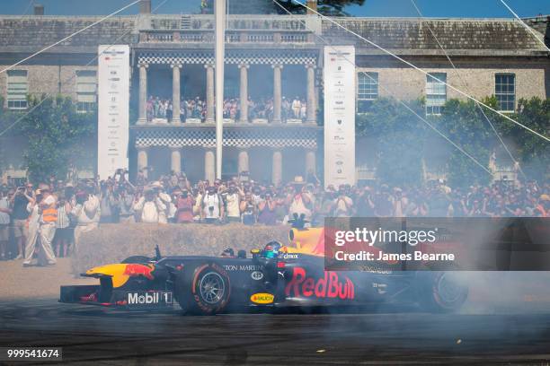 Patrick Friesacher of Austria performs donuts in the Red Bull Racing RB8 during the Goodwood Festival of Speed at Goodwood on July 15, 2018 in...