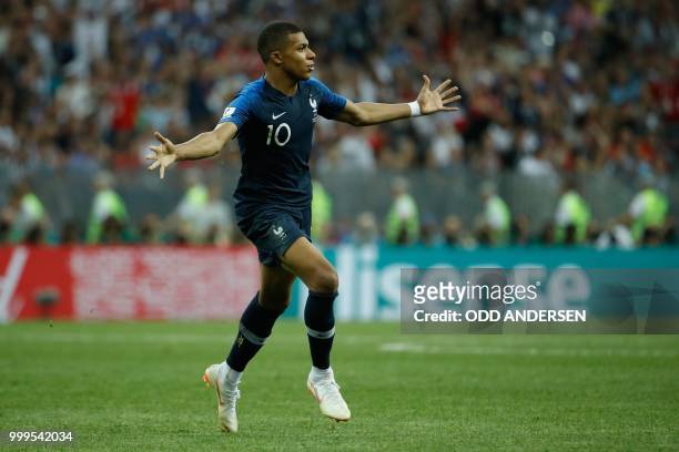 France's forward Kylian Mbappe celebrates scoring the 4-1 goal during the Russia 2018 World Cup final football match between France and Croatia at...