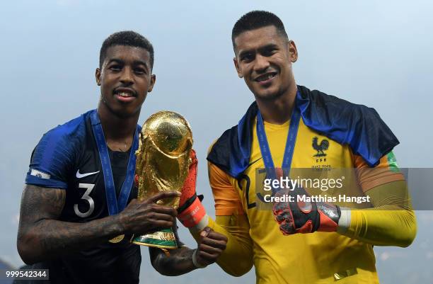 Presnel Kimpembe and Alphonse Areola of France celebrate with the World Cup trophy following the 2018 FIFA World Cup Final between France and Croatia...