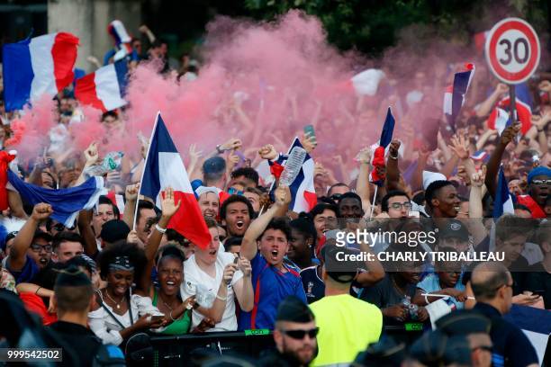 People react as they watch on the fan zone the Russia 2018 World Cup final football match between France and Croatia, on the Champ de Mars in Paris...