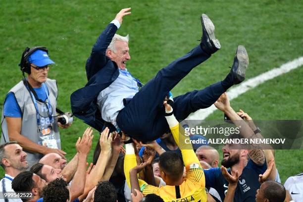 France's coach Didier Deschamps celebrates with his team players at the end of the Russia 2018 World Cup final football match between France and...