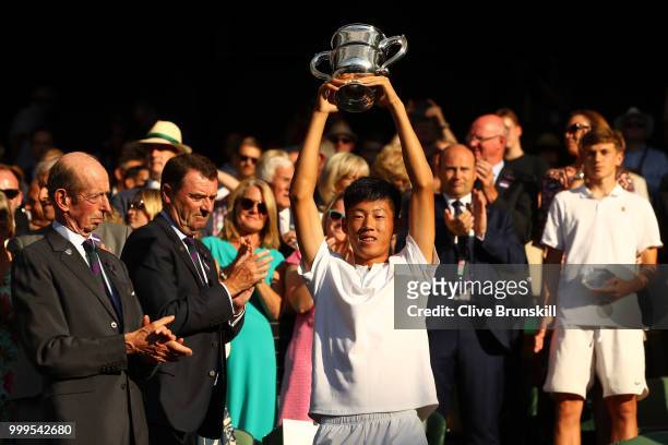 Chun Hsin Tseng of Taiwan, winner of the Boys' Singles final, celebrates with the trophy at Centre Court on day thirteen of the Wimbledon Lawn Tennis...