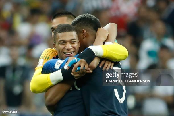 France's forward Kylian Mbappe reacts with his teammates after the final whistle of the Russia 2018 World Cup final football match between France and...