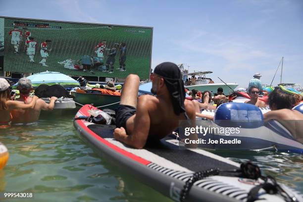 People watch France playing against Croatia in the World Cup final as it is being broadcast from the Ballyhoo Media boat setup in the Intracoastal...