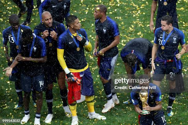 Kylian Mbappe of France celebrates with the World Cup trophy with team mates following the 2018 FIFA World Cup Final between France and Croatia at...