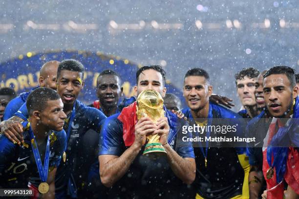 Adil Rami of France celebrates with the World Cup trophy with team mates following the 2018 FIFA World Cup Final between France and Croatia at...