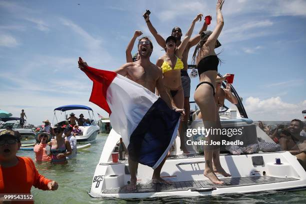 People react to France scoring their 4th goal against Croatia in the World Cup final as it is being broadcast from the Ballyhoo Media boat setup in...