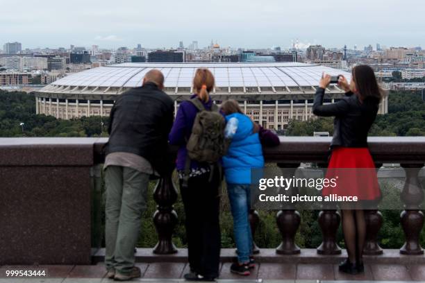 Passers-by standing on a hill with a view to the Luzhniki Olympic Stadium in Moscow, Russia, 29 August 2017. The city is one of the locations for the...