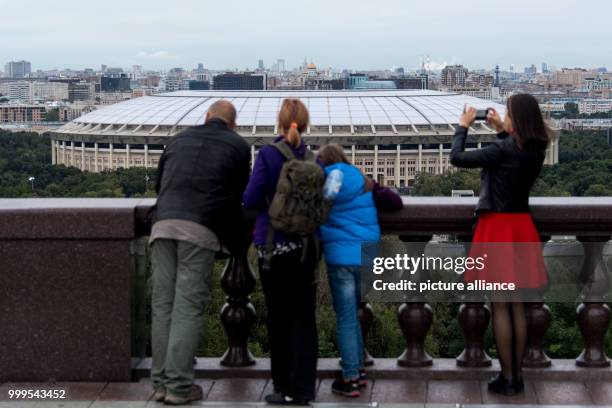 Passers-by standing on a hill with a view to the Luzhniki Olympic Stadium in Moscow, Russia, 29 August 2017. The city is one of the locations for the...