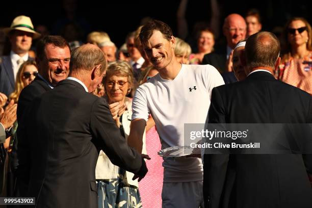 Jamie Murray of Great Britain and Victoria Azarenka of Belarus are presented with their trophies after losing the Mixed Doubles final against...