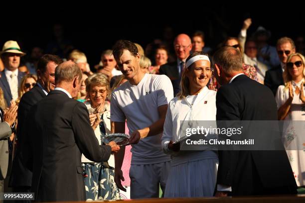 Jamie Murray of Great Britain and Victoria Azarenka of Belarus are presented with their trophies after losing the Mixed Doubles final against...