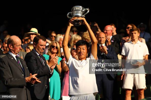 Chun Hsin Tseng of Taiwan, winner of the Boys' Singles final, celebrates with the trophy at Centre Court on day thirteen of the Wimbledon Lawn Tennis...