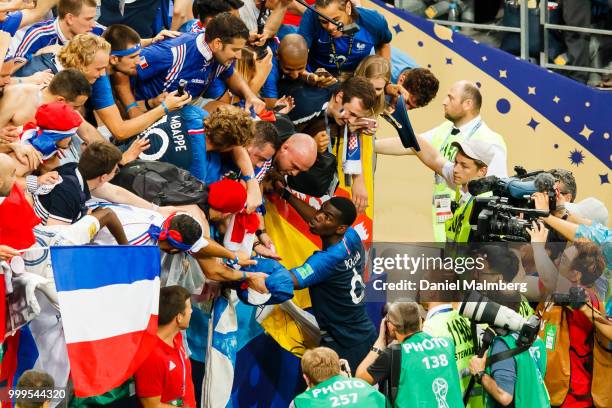 Paul Pogba of France celebrates the victory together with French fans after the 2018 FIFA World Cup Russia Final between France and Croatia at...