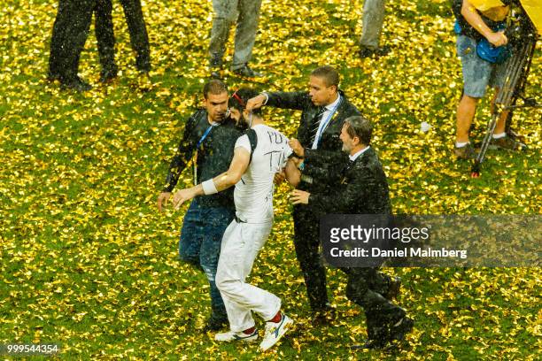 Person who protested agains Russias President Vladimir Putin gets removed from the plying field and the price ceremony after the 2018 FIFA World Cup...