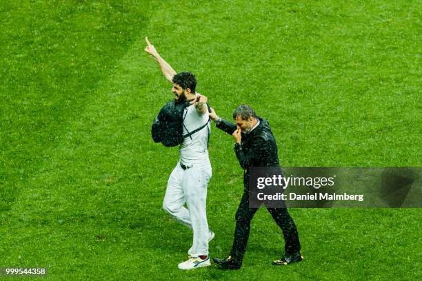 Person who protested agains Russias President Vladimir Putin gets removed from the plying field and the price ceremony after the 2018 FIFA World Cup...