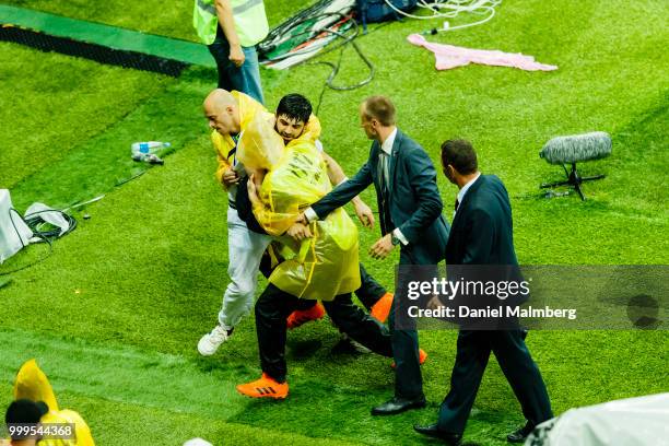 Person who protested agains Russias President Vladimir Putin gets removed from the plying field and the price ceremony after the 2018 FIFA World Cup...