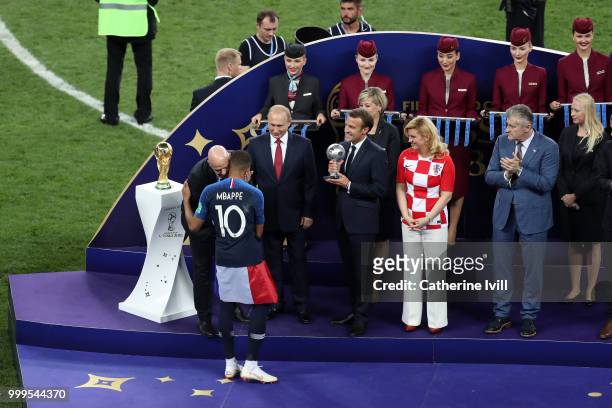 President Gianni Infantino, greets Kylian Mbappe of France as French President Emmanuel Macron prepares to present him with the FIFA Young Player...