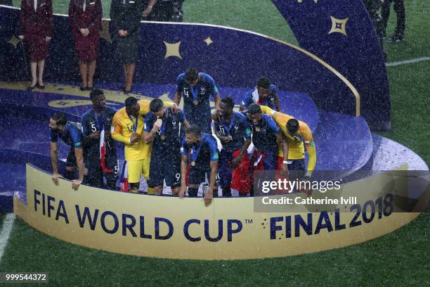 France players gather round after reciveing their Winners Medals, ready to be awarded with the World Cup Trophy after the 2018 FIFA World Cup Final...