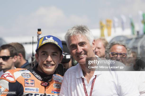 Marc Marquez of Spain and Repsol Honda Team celebrates with Michael Doohan of Australia under the podium at the end of the MotoGP race during the...