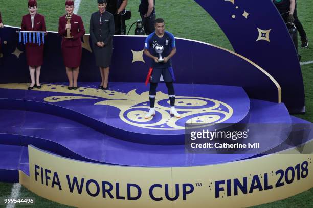 Kylian Mbappe of France celebrates with his Best Young Player Award following the 2018 FIFA World Cup Final between France and Croatia at Luzhniki...