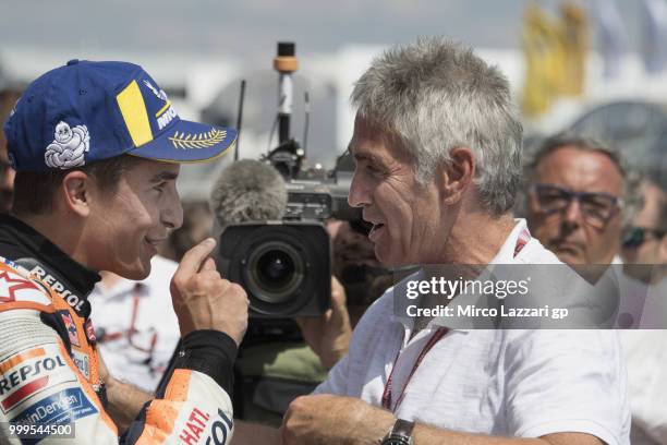 Marc Marquez of Spain and Repsol Honda Team celebrates with Michael Doohan of Australia under the podium at the end of the MotoGP race during the...