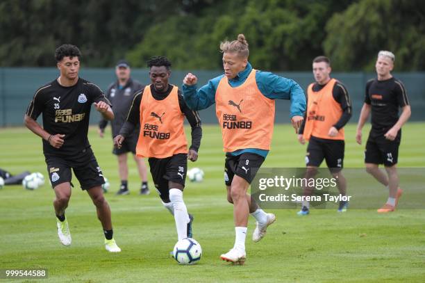 Dwight Gayle controls the ball whilst Christian Atsu blocks a challenging Josef Yarney during the Newcastle United Training session at Carton House...