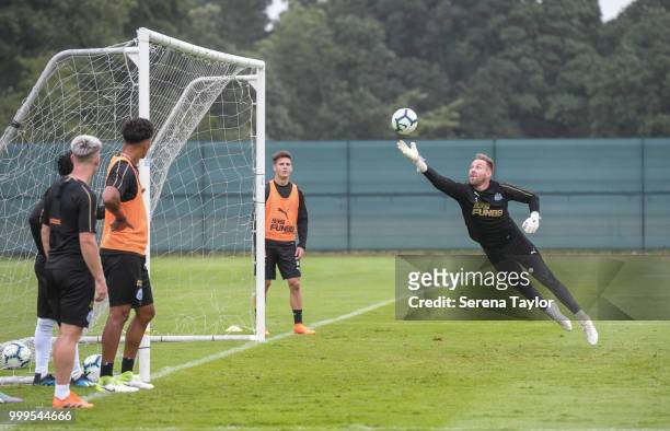 Goalkeeper Rob Elliot jumps in the air to make a diving save during the Newcastle United Training session at Carton House on July 15 in Kildare,...
