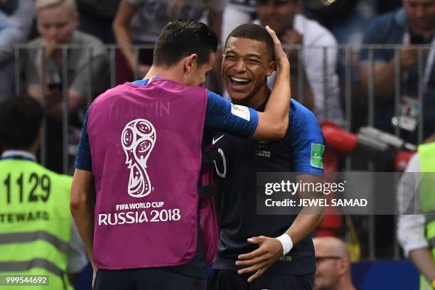 France's forward Kylian Mbappe celebrates his goal with France's forward Florian Thauvin during the Russia 2018 World Cup final football match...