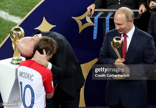 President Gianni Infantino greets Luka Modric of Croatia as President of the Russian Federation, Vladimir Putin, prepares to award him with his...