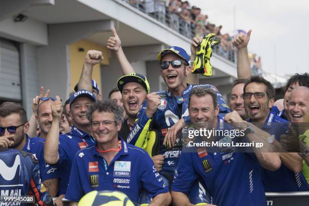 Valentino Rossi of Italy and Movistar Yamaha MotoGP celebrates the second place with team under the podium at the end of the MotoGP race during the...