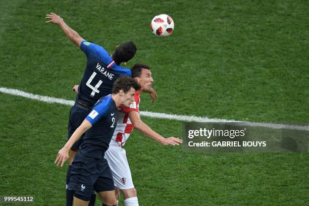 France's defender Raphael Varane heads the ball during the Russia 2018 World Cup final football match between France and Croatia at the Luzhniki...