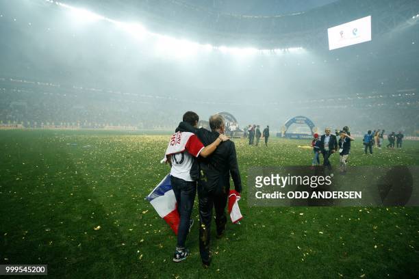 France's coach Didier Deschamps celebrates with family after the Russia 2018 World Cup final football match between France and Croatia at the...