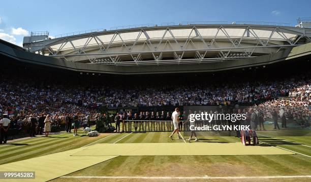 Serbia's Novak Djokovic holds the winners trophy after beating South Africa's Kevin Anderson 6-2, 6-2, 7-6 in their men's singles final match on the...