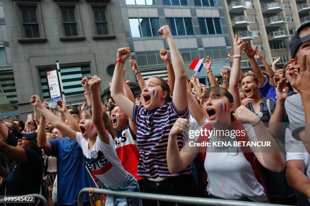 French fans react as France scores a goal, while they watch the World Cup final match between France vs Croatia on July 15, 2018 in New York. - The...