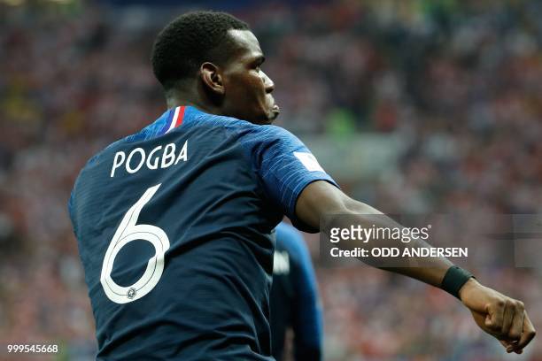 France's midfielder Paul Pogba celebrates scoring the 3-1 goal during the Russia 2018 World Cup final football match between France and Croatia at...