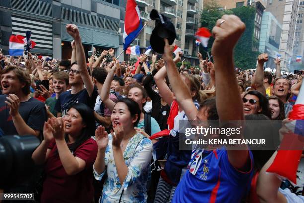 French fans react as France scores a goal, while they watch the World Cup final match between France vs Croatia on July 15, 2018 in New York. - The...