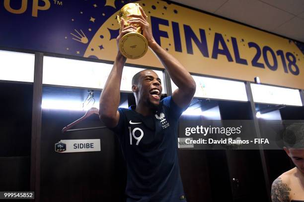 Djibril Sidibe of France celebrates with the World Cup Trophy in the dressing room following his sides victory in the 2018 FIFA World Cup Final...